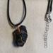 The back , attached to cord by jump ring